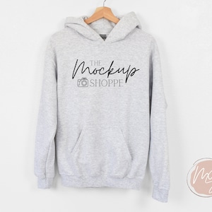 May include: A gray hooded sweatshirt with a black graphic that says "THE Mockup SHOPPE" with a camera icon.