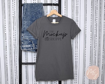 May include: A charcoal gray t-shirt with a black graphic that says "The Mockup Shoppe" with a camera icon.