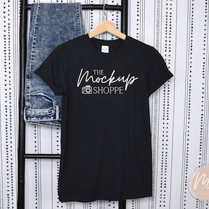 May include: Black t-shirt with white text that reads "The Mockup Shoppe" and a camera icon.