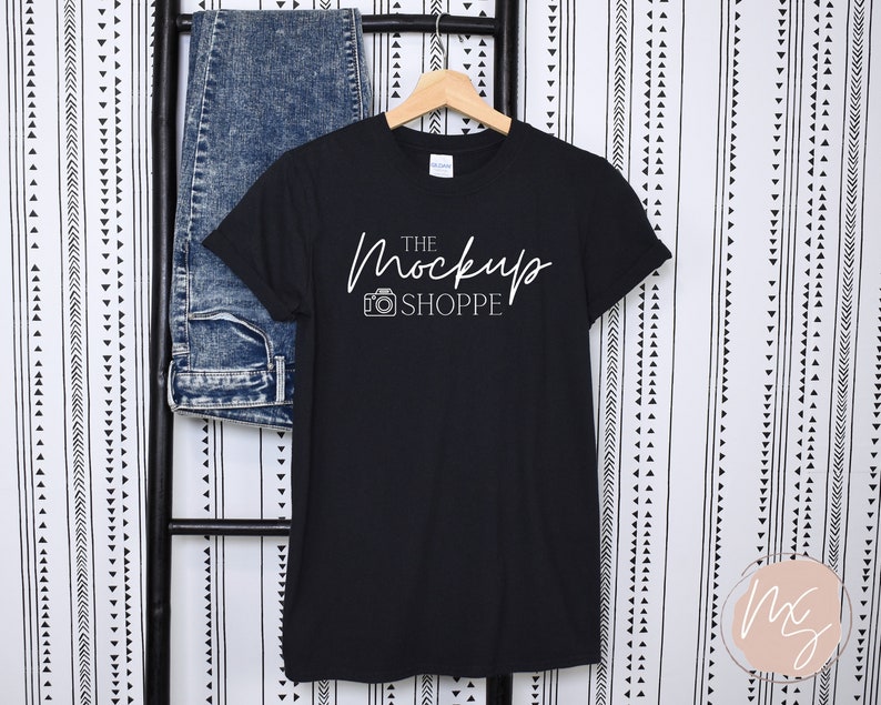 May include: Black t-shirt with white text that reads "The Mockup Shoppe" and a camera icon.