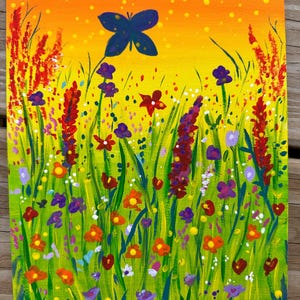May include: A vibrant acrylic painting of a wildflower meadow. The artwork features a blue butterfly against an orange and yellow sky. Colorful flowers in red, orange, purple, and white bloom in a field of green grass.