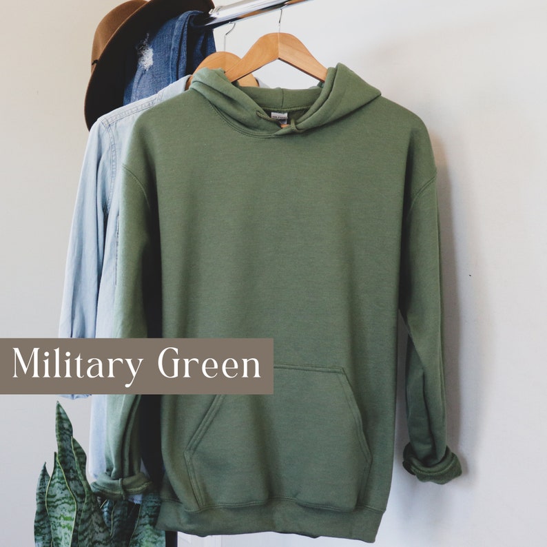 May include: A military green hooded sweatshirt with a kangaroo pocket.