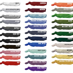May include: A collection of hair ties in various colors, each labeled with its corresponding shade. Colors include white, black, red, blue, green, and purple, with names like "Cardinal," "Navy," and "Forest." The ties are knotted and displayed against a white background.