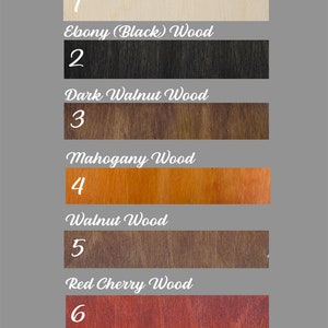 May include: A chart showing seven different wood colors with their names and numbers. The colors are: Natural Wood, Ebony (Black) Wood, Dark Walnut Wood, Mahogany Wood, Walnut Wood, Red Cherry Wood, and Wenge Wood.