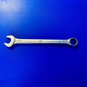 May include: A silver wrench with a 3/4 inch opening. The wrench is labeled "ZEB 24" and "USA".