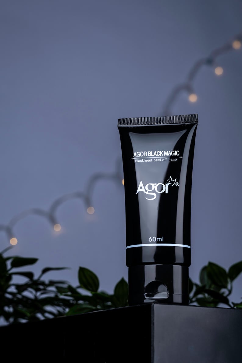 May include: A black tube of face mask with the text "AGOR BLACK MAGIC Blackhead peel-off mask Agor" and "60ml" printed on the front.