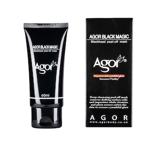 May include: Black tube of Agor Black Magic blackhead peel-off mask with a 60ml label. The packaging is black with white text. The product is next to a black and white box with the same product name and description. The box says "improves skin youthful glow" and "Increases Vitality".