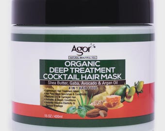 May include: A white jar of Agor Organic Deep Treatment Cocktail Hair Mask with a black lid. The label includes text and illustrations of ingredients like shea butter, avocado, and argan oil. The jar contains 15 oz of product.