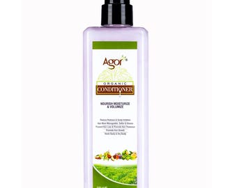 May include: A light purple rectangular bottle of Agor Organic Conditioner with a black pump dispenser. The label features green accents, text reading Nourish Moisturize & Volumize, and a graphic of a green field. The bottle contains 500 ml.