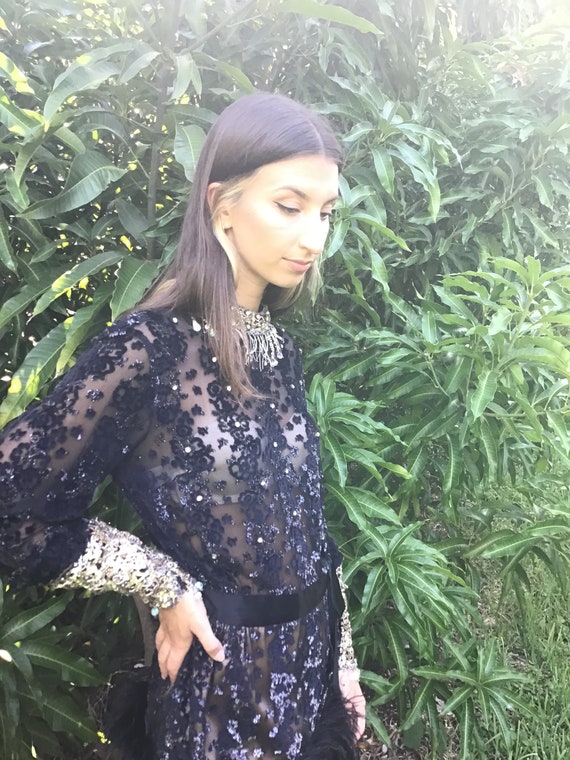 Evening dress with rhinestones and feather hemline