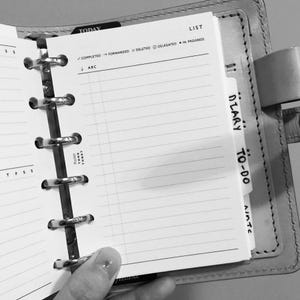 May include: A black and white image of a planner with a tab labeled "DIARY TO-DO". The planner has a list of tasks with checkboxes for completed, forwarded, deleted, delegated, and in progress.