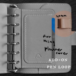 May include: Gray leather planner cover with a pen loop add-on. The loop is 20mm wide and designed to fit a ring planner. The text "for ring planner cover" is handwritten on the cover.