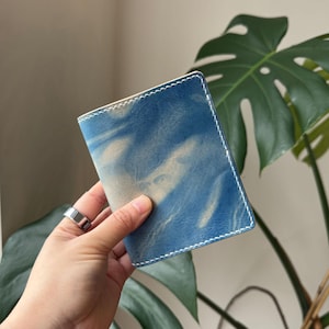 May include: A set of three ceramic mugs with a speckled, matte finish. The mugs are in shades of cream, light gray, and dark gray. Each mug has a simple, minimalist design, perfect for coffee or tea.