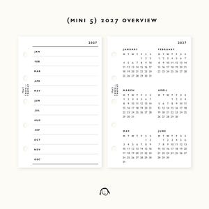 May include: A white planner insert set labeled (MINI 5) 2027 OVERVIEW. The left page features a list of months from January to December with horizontal lines. The right page displays a 2027 calendar for January through June. Both pages have five binder holes.