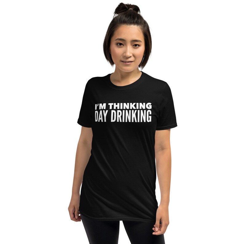 May include: Black short-sleeved t-shirt with white text that reads "I'm thinking day drinking."