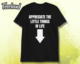 May include: Black t-shirt with white text that reads "Appreciate the little things in life" and a white downward arrow.