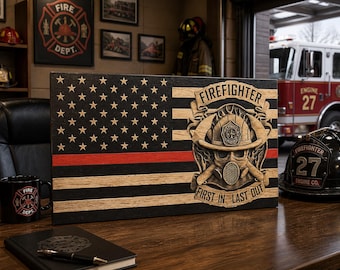 May include: Wooden American flag with a red stripe, stars, and the words "Firefighter, First In Last Out." The flag features a firefighter's helmet and gear. A black mug with a fire department logo and a black notebook are also visible.