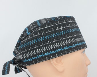 May include: Black scrub hat with a blue and white EKG pattern. The hat has a tie at the back.