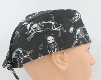 May include: Black scrub hat with a white skeleton cat print.