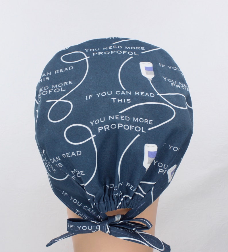 May include: A dark blue scrub hat with a white pattern of IV bags and the text "If you can read this you need more propofol".