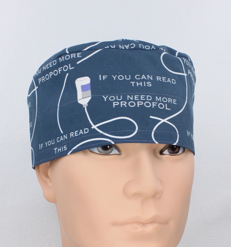 May include: A dark blue scrub hat with a white IV drip design and the text "If you can read this you need more propofol".