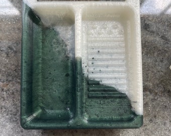 May include: A two-compartment tray with a green and white color scheme. The tray is made of a textured plastic material.