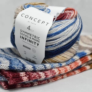May include: A ball of multicolored yarn with a label that reads "CONCEPT BY KATIA 4 PLY SYMMETRIC SOCKS & MORE INFINITY." Below the yarn are three pairs of knitted socks in coordinating colors, including blue, red, and beige.