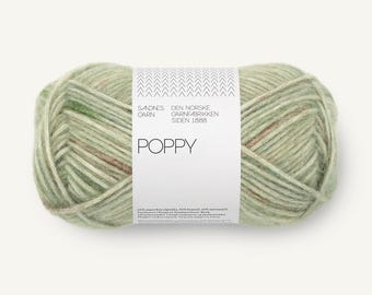 May include: A skein of light sage green yarn with subtle brown and white flecks. A white paper label wraps around the center, featuring the text Sandnes Garn, Den Norske Garnfabrikken Siden 1888, and Poppy, along with small chevron patterns.