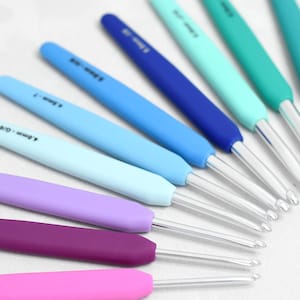 Pode incluir: Um conjunto de 10 agulhas de crochê em vários tamanhos, variando de 2,0 mm a 5,0 mm. As agulhas têm alças coloridas e graduadas em tons de roxo, rosa, azul e verde. As agulhas são feitas de metal e têm um acabamento claro e liso.