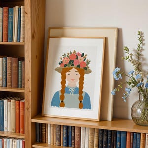 May include: A framed art print featuring a stylized illustration of a person with long ginger braids, wearing a straw hat adorned with a vibrant floral arrangement of pink, red, and orange flowers, a blue shirt, and a light gray apron against a white background.