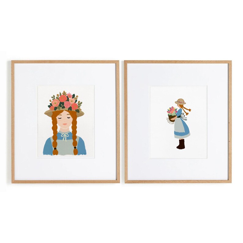 May include: Two framed art prints featuring a character with red braided hair wearing a straw hat and blue dress. The left print shows a close-up with a floral crown, while the right print shows a full-body view holding a basket of flowers.