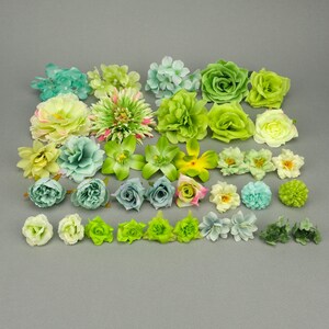 May include: Assortment of artificial flowers in various shades of green, white, and yellow. The flowers are made of fabric and have a realistic appearance. They are perfect for crafting and decorating.