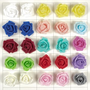May include: A grid of colorful artificial rose flowers in various shades, including white, yellow, blue, pink, red, green, and purple. The roses are arranged in rows and columns, showcasing their different colors and textures.