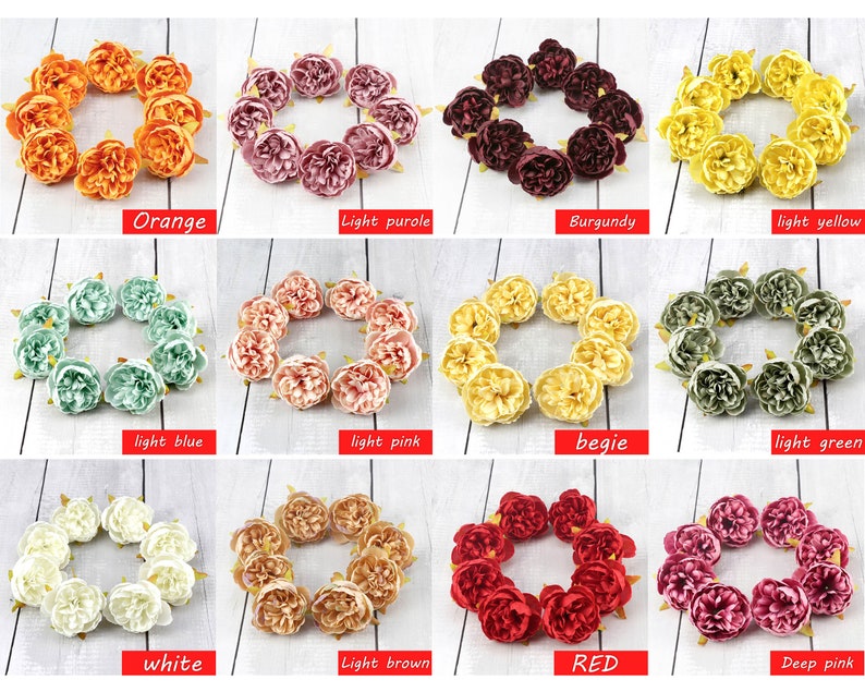May include: Assortment of 12 artificial flower wreaths in various colors, including orange, light purple, burgundy, light yellow, light blue, light pink, beige, light green, white, light brown, red, and deep pink. Each wreath is made of small, fabric flowers.