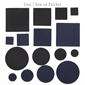 May include: An assortment of iron-on and sew-on patches in various shapes and sizes. The patches are primarily black and navy blue, including squares and circles. The text "Iron / Sew on Patches" is at the top.