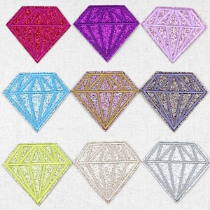 May include: Nine diamond-shaped iron-on patches in various colours, including pink, purple, blue, gold, silver, and grey. Each patch has a glitter finish.