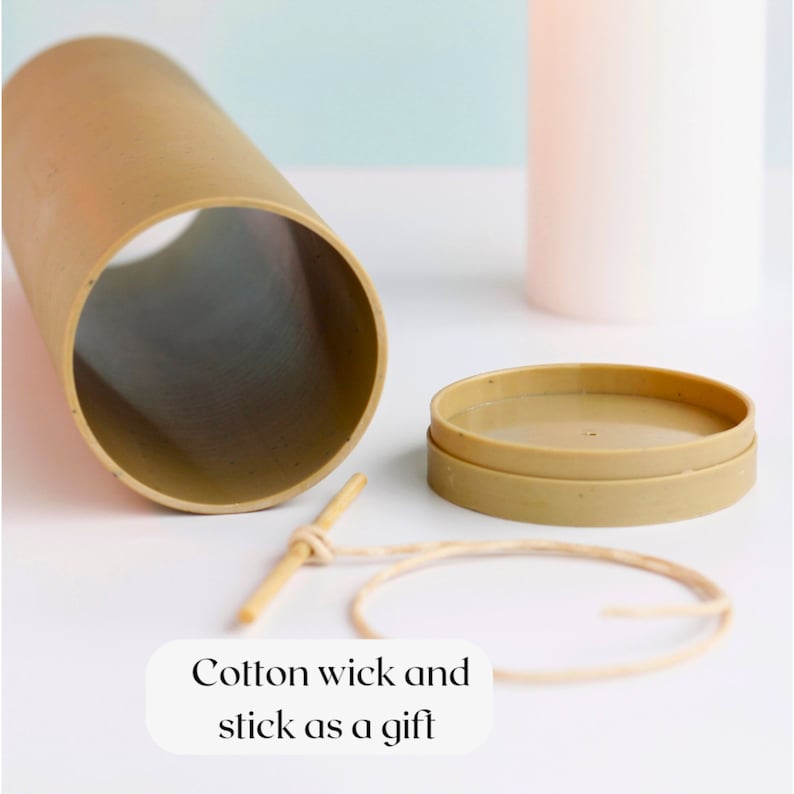 May include: A brown cardboard tube with a lid, a wooden stick, and a length of twine. The text "Cotton wick and stick as a gift" is printed below the items.