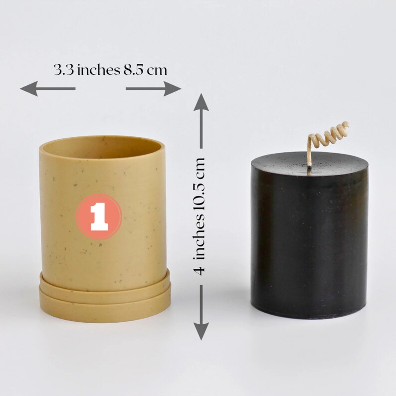 May include: A beige candle mold with a number "1" printed on the side, next to a black pillar candle with a brown wick. The candle mold is 3.3 inches wide and 4 inches tall. The candle is 8.5 cm wide and 10.5 cm tall.