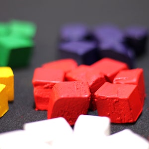 May include: A close-up of a set of colorful, geometric shaped blocks. The blocks are made of a textured material and are arranged in a circle. The colors of the blocks are red, yellow, green, blue, and white.