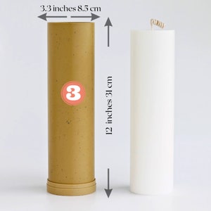 May include: Two pillar candles, one is a light brown color with a speckled texture and the other is white. Both candles are 12 inches tall and 3.3 inches in diameter.