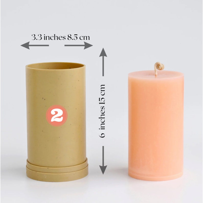 May include: A beige candle mold with a 2 printed on it, next to a peach-colored candle with a wick. The mold is 6 inches tall and 3.3 inches wide. The candle is 6 inches tall and 3.3 inches wide.
