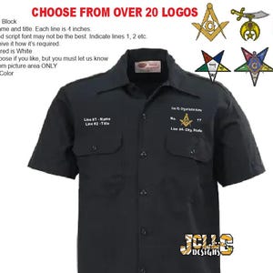 May include: A black short-sleeved button-down work shirt featuring embroidered text and a Masonic square and compass emblem on the chest. The shirt includes two front pockets with button flaps and a central button closure. Text includes Line #1 Name, Line #2 Title, Line #3 Organization Name, and Line #4 City, State.