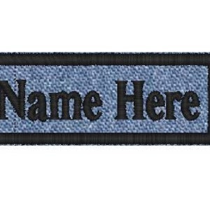 May include: A blue denim name tag with black stitching and a black border. The text "Name Here" is embroidered in black.