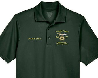 May include: A dark green polo shirt with a gold embroidered design featuring a sword, a star, and the text "Temple Name No. ?? Oasis of City Desert of State". The shirt also has the text "Name/Title" embroidered on the left side.