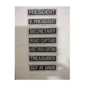 May include: Seven black and white rectangular patches with white text on a white background. The patches read: President, V. President, Secretary, Road Captain, Asst. Road Captain, Treasurer, Sgt. At Arms.