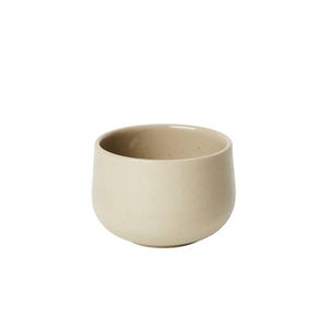 Peut inclure: Un petit bol en céramique beige de forme arrondie. Le bol a une texture mouchetée et une finition lisse et mate. L'intérieur est d'une nuance de beige légèrement plus foncée. Le bol est conçu pour servir des aliments ou comme objet décoratif.