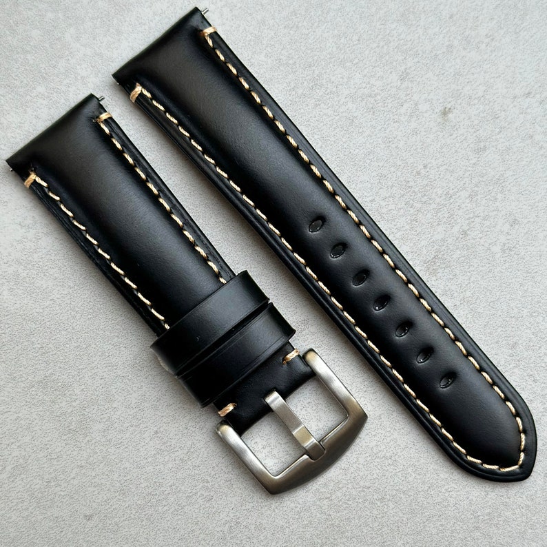 Oslo black full grain leather watch strap with brushed 316L stainless steel buckle. Jet black padded leather watch strap with contrast ivory stitching.