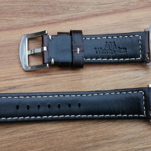 Underside of the Berlin brown leather apple watch strap. Picture shows the Watch and Strap logo debossed into the rear of the strap and the soft black leather lining.