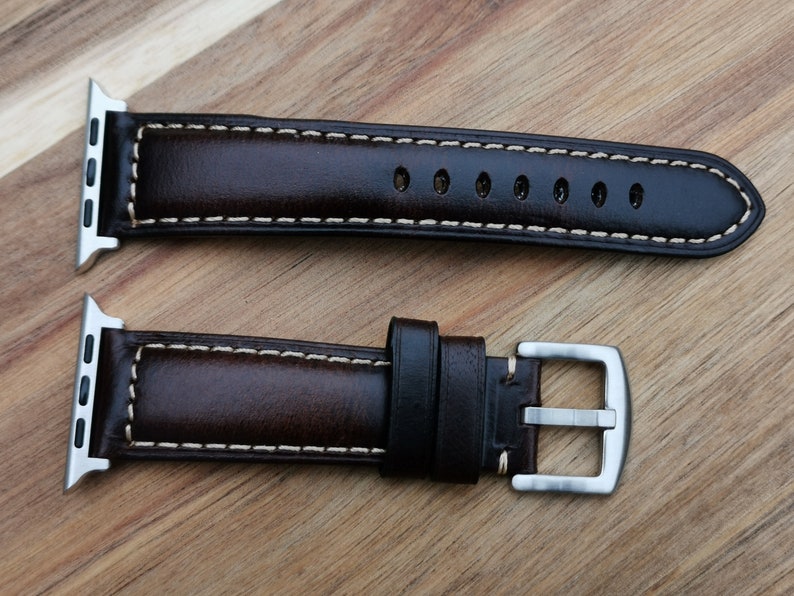 Birds eye view shot of the Berlin brown leather apple watch strap. With contrast light old stitching and a 316L stainless steel buckle.