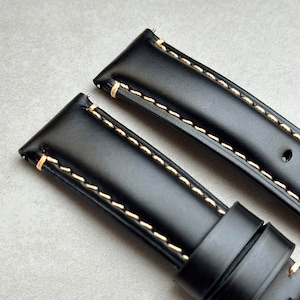Top of the Oslo jet black full grain leather watch strap. Contrast ivory stitching. Smooth grain leather.